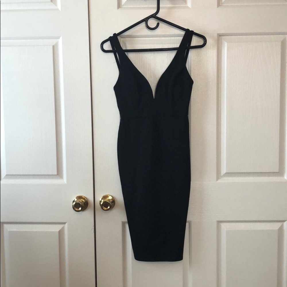 Form fitting little black dress with open back